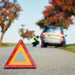 A red and yellow triangle on the side of a road.