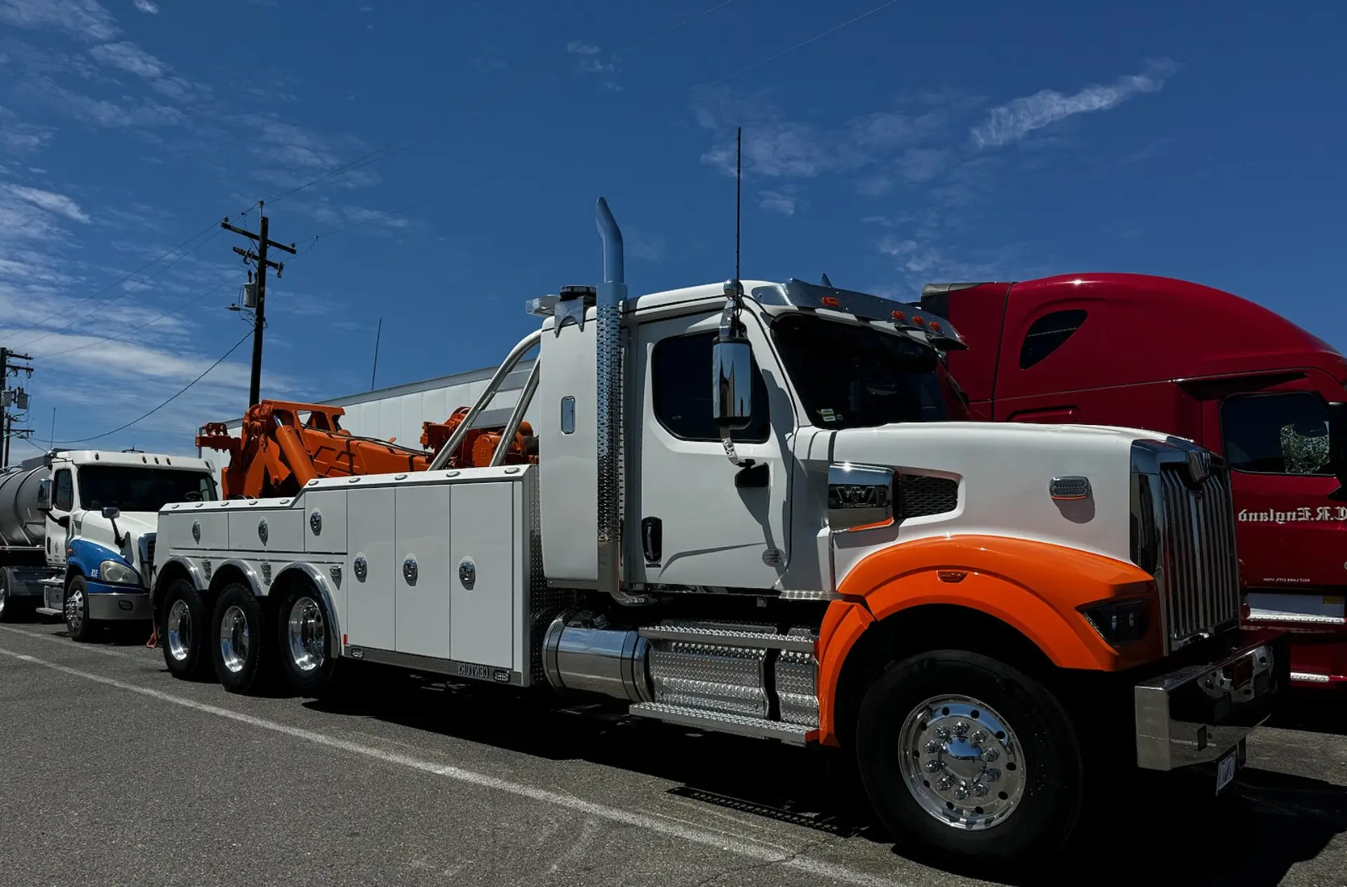 A tow truck is parked on the side of the road.