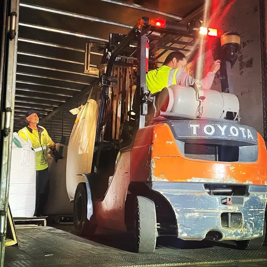 A forklift is parked in the middle of an open door.