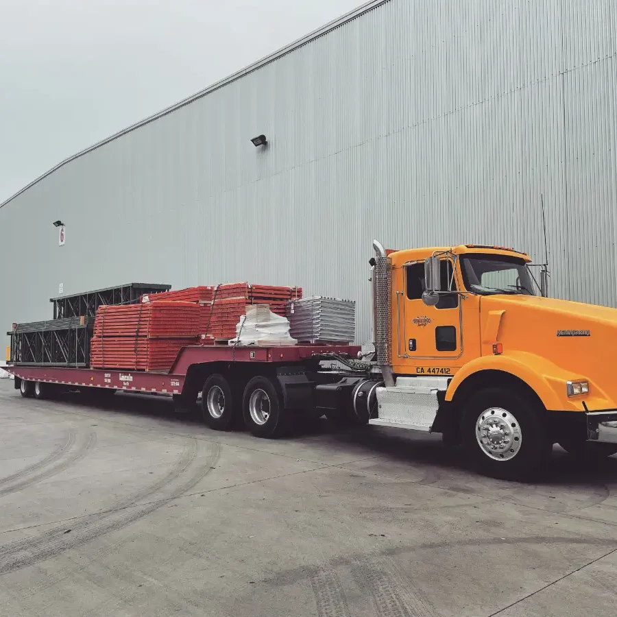 A large truck is parked in front of a building.