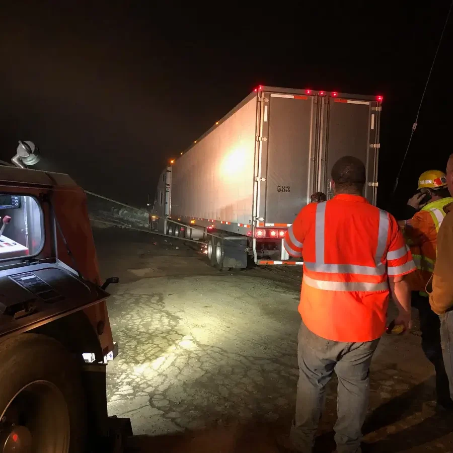 A group of people standing around a truck.