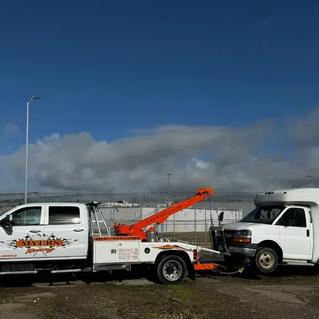 A tow truck parked next to another tow truck.