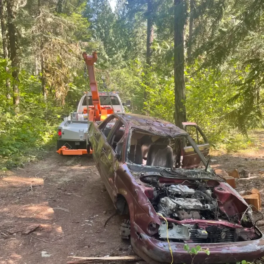 A car that is being towed by a crane.